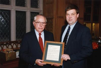 George Ware Retirement Party in Founders Room - holding framed statement - George Ware (left) and Patrick Kelsey