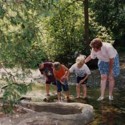 Mary Toohey and students in a stream