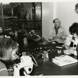 Bill Hess and class in Botany Lab examining specimens