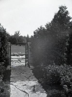 Stone path and iron gate in Morton residence garden