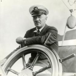 Sterling Morton behind steering wheel of yacht