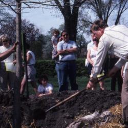 Craig Johnson planting tree at Arborfest with visitors
