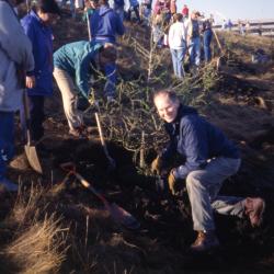 Tom Green and others planting tree on berm on Earth Day