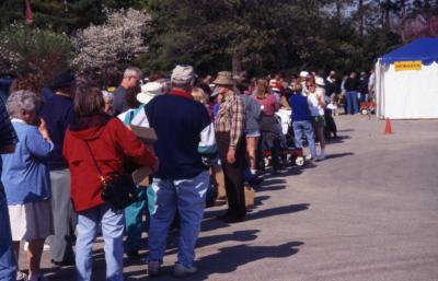 Long line of customers waiting outside Arbor Day Plant Sale tent