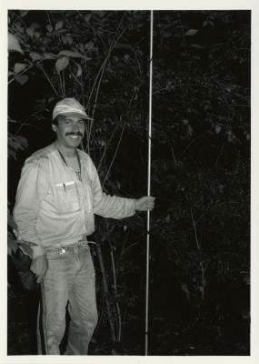 Chris Whelan holding metal pole and stick