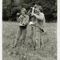 Chris Whelan and two others with binoculars in the field for bird study