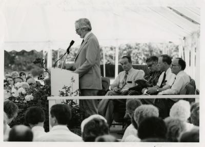 Research Building dedication - Russell Beatty, keynote speaker, at podium in tent - (Seated L to R): George Ware, Suzette Morton Davidson, Charles Haffner III, Marion Hall