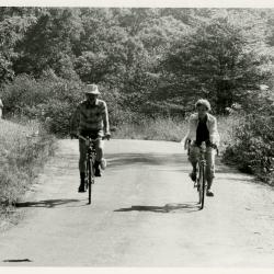Members' bike ride, Kitty Kohout at edge of woods