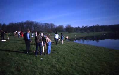Groups planting trees near Crabapple Lake during Earth Day celebration and berm planting