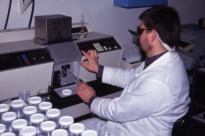 Pat Kelsey seated in lab working with equipment