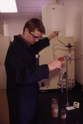 Researcher testing soil in lab