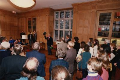 George Ware Retirement Party in Founders Room - Overview with George Ware waving book