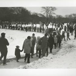 Yule Log Hunt - group walking in snow in the East Side of the Arboretum