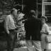 Alfred Etter speaking with man and woman outside, contact sheet