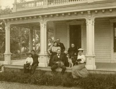 Morton family seated on porch outside of Arbor Lodge