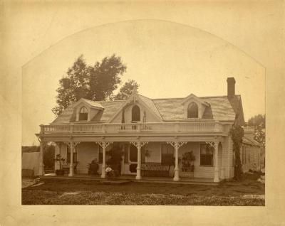 Carl Morton sitting on porch in front of Arbor Lodge house