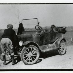 Clarence E. Godshalk with Model T car and dog Punch