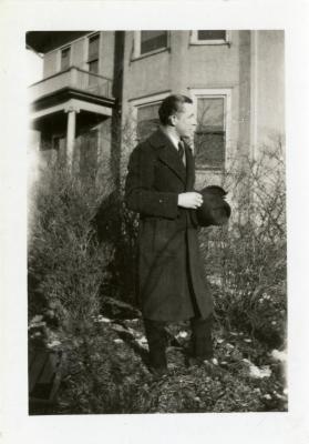 Clarence E. Godshalk dressed in a suit outside South Farm house
