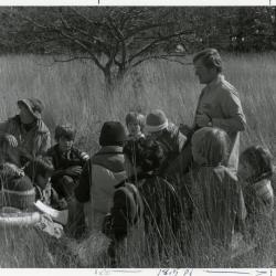 Craig Johnson with school group in tall grass