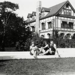 Morton residence at Thornhill, Clarence Godshalk and two women sitting at pool in south lawn with house in background