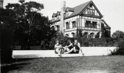Morton residence at Thornhill, Clarence Godshalk and two women sitting at pool in south lawn with house in background