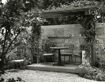 May T. Watts Reading Garden, pergola with clay tiles commemorating botanists along shelf on wall