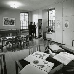 Herbarium, two men viewing specimens from cabinet