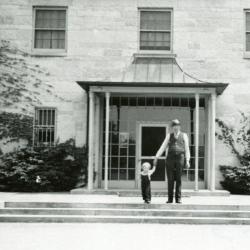 Administration Building, man and child in front of entrance