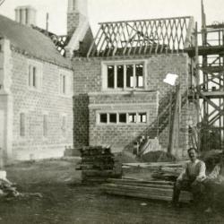 Morton Residence at Thornhill, exterior, construction, with two men sitting in foreground