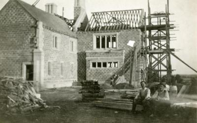 Morton Residence at Thornhill, exterior, construction, with two men sitting in foreground