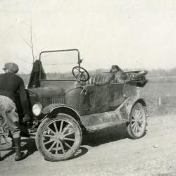 Clarence E. Godshalk and his dog, Punch, with Joy Morton's castoff Model T car