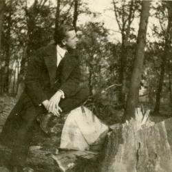 Clarence E. Godshalk sitting on a fallen oak in the woodlands, north of Lake Marmo