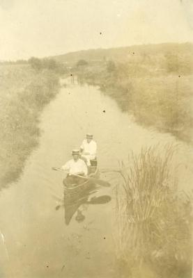 Clarence E. Godshalk and Emil Heineman canoeing on the DuPage River behind his house
