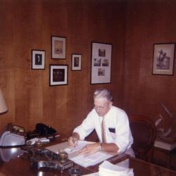 Clarence Godshalk in his office working at desk 