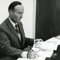 Marion T. Hall working at his desk