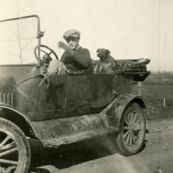 Clarence E. Godshalk and his dog, Punch, inside Joy Morton's castoff Model T car