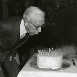 Clarence E. Godshalk's 90th birthday celebration scrapbook: Clarence Godshalk blowing out 90 candles on his birthday cake