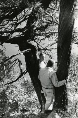 Dr. Marion T. Hall with Dick Young leaning against 850 year old juniper along bluffs of the Fox River