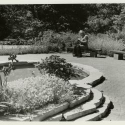 John Kohout seated on bench in Fragrance Garden
