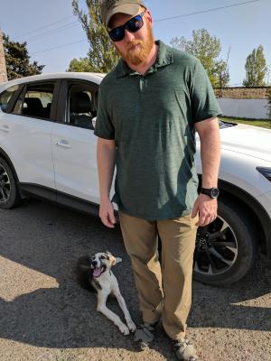 Phil Douglas with stray dog, Azerbaijan