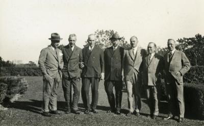 Joy Morton September 27, 1930 photo album: Joy Morton standing with group of men