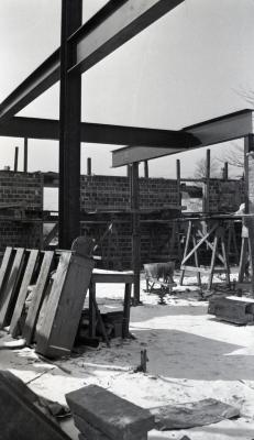  Administration Building construction, view from inside construction site showing crossbeams and brick work in winter