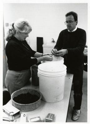 Mike Spravka and volunteer cleaning seeds in Research Building basement in preparation for seed exchange