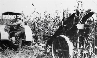 Man using corn binder in field at Lisle Farms
