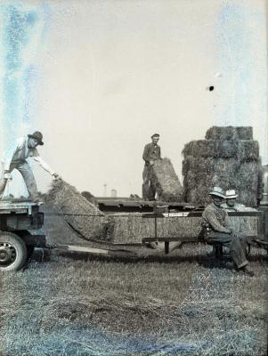 Men with baled hay on trailer at Lisle Farms