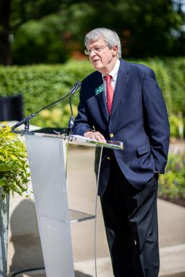 Steve Van Arsdell Speaking at a Podium for The Gerard T. Donnelly Grand Garden Ribbon Cutting Luncheon