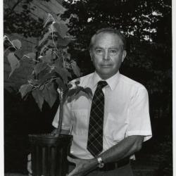 George Ware outdoors holding plant