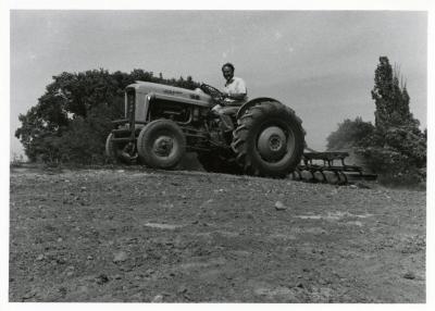 Tony Tyznik driving tractor over landscape