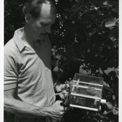 Dr. Gary Watson outside, using Licor photosynthesis system