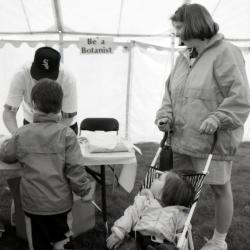 Arbor Day activities at The Morton Arboretum, woman and two children at Be A Botanist station